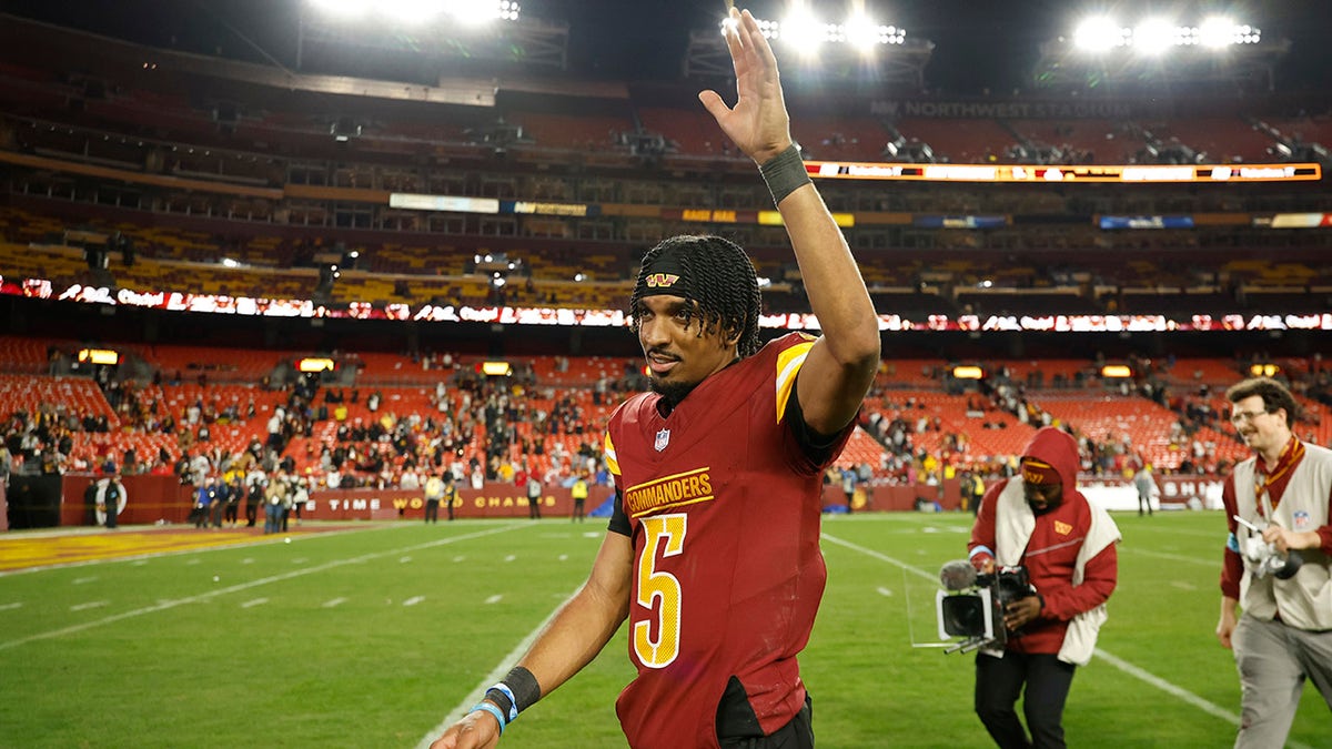 Jayden Daniels waves to the crowd