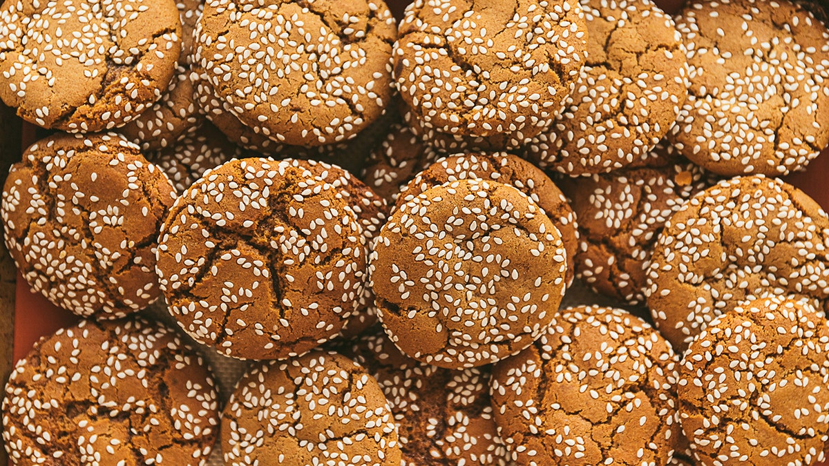 Sesame ginger snaps cooling on a rack.