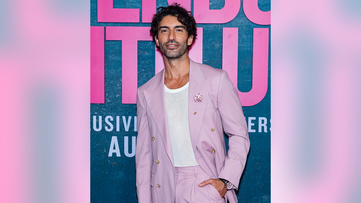 Justin Baldoni wears a two piece baby pink suit on the carpet