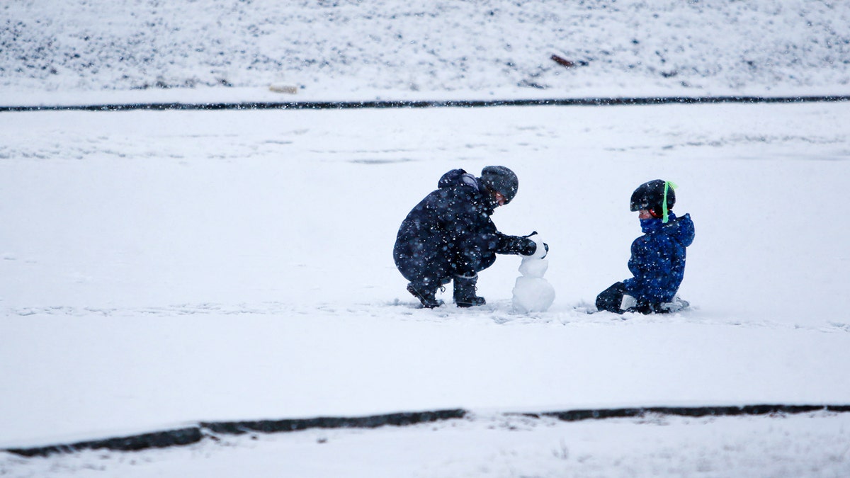 Kids building a snowman