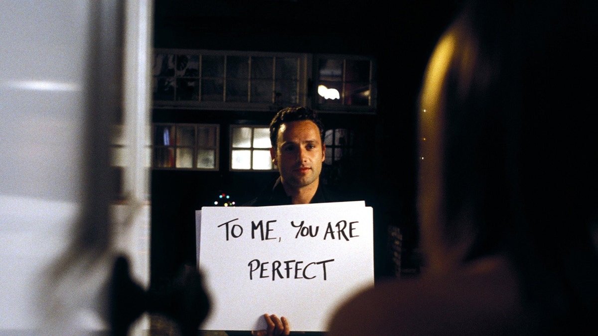 Andrew Lincoln in "Love Actually" as Mark holding up a cue card that says, 'To me, you are perfect'