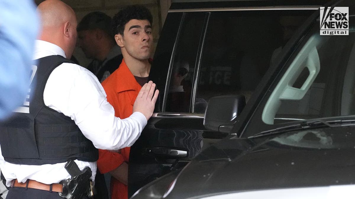 Luigi Mangione is led into an NYPD vehicle following his extradition hearing at Blair County Courthouse in Holladaysville, Pennsylvania, Thursday, December 19, 2024. Mangione is being charged with the murder of United Healthcare CEO, Brian Thompson.