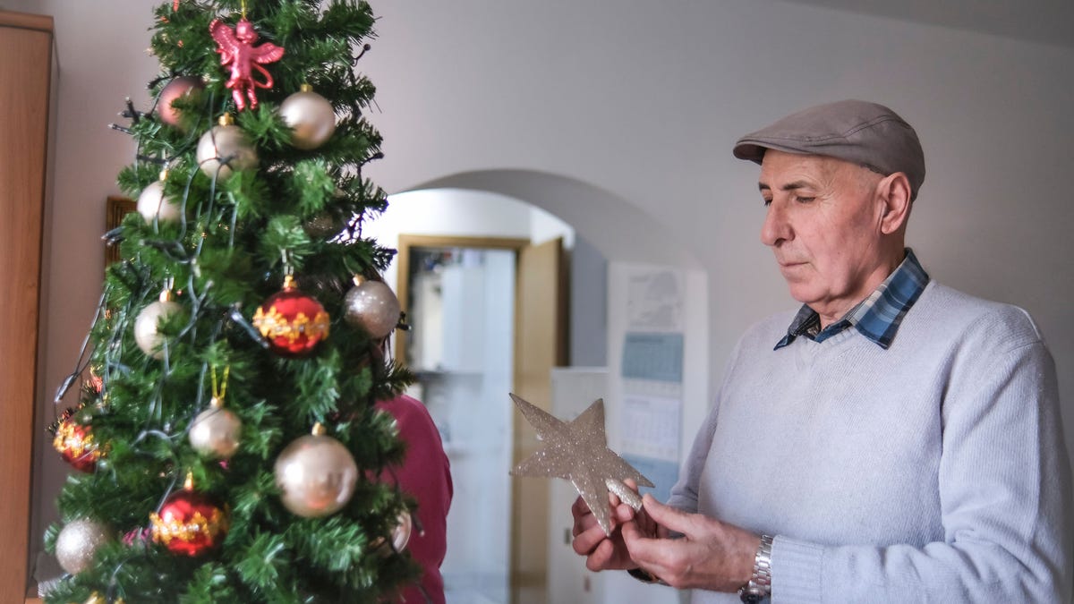 man decorating tree