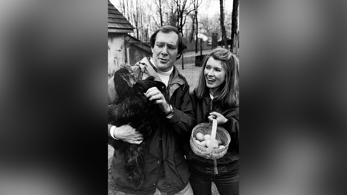 Martha Stewart and her husband at their home with chickens