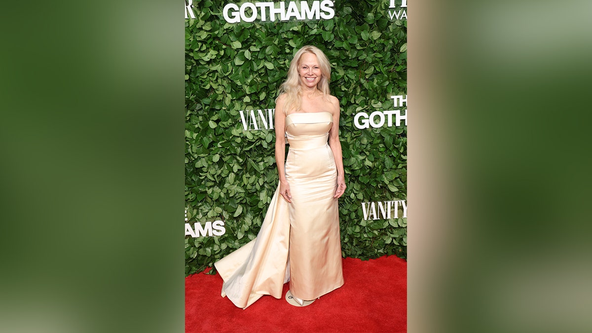 Pamela Anderson in a figure-hugging yellow gown at the Gotham Awards