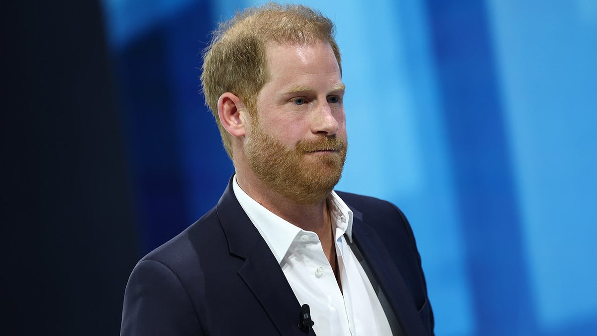 Prince Harry wears a blue suit to speak at the DealBook Summit.