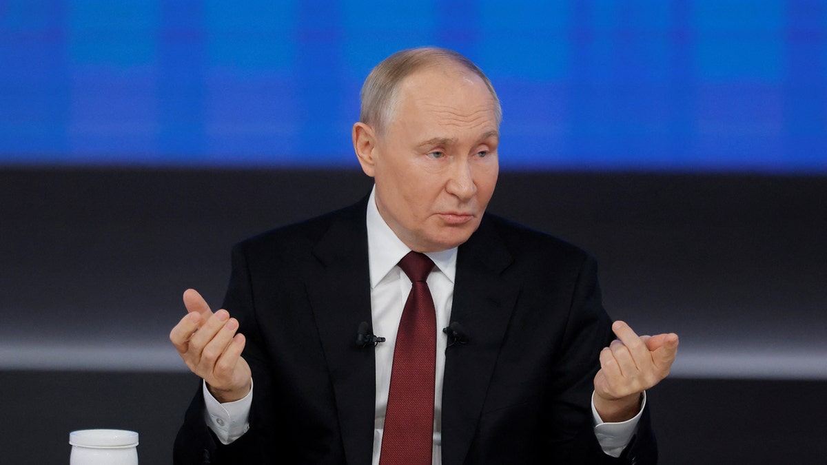 Russian President Vladimir Putin gestures at his end-of-year press conference.