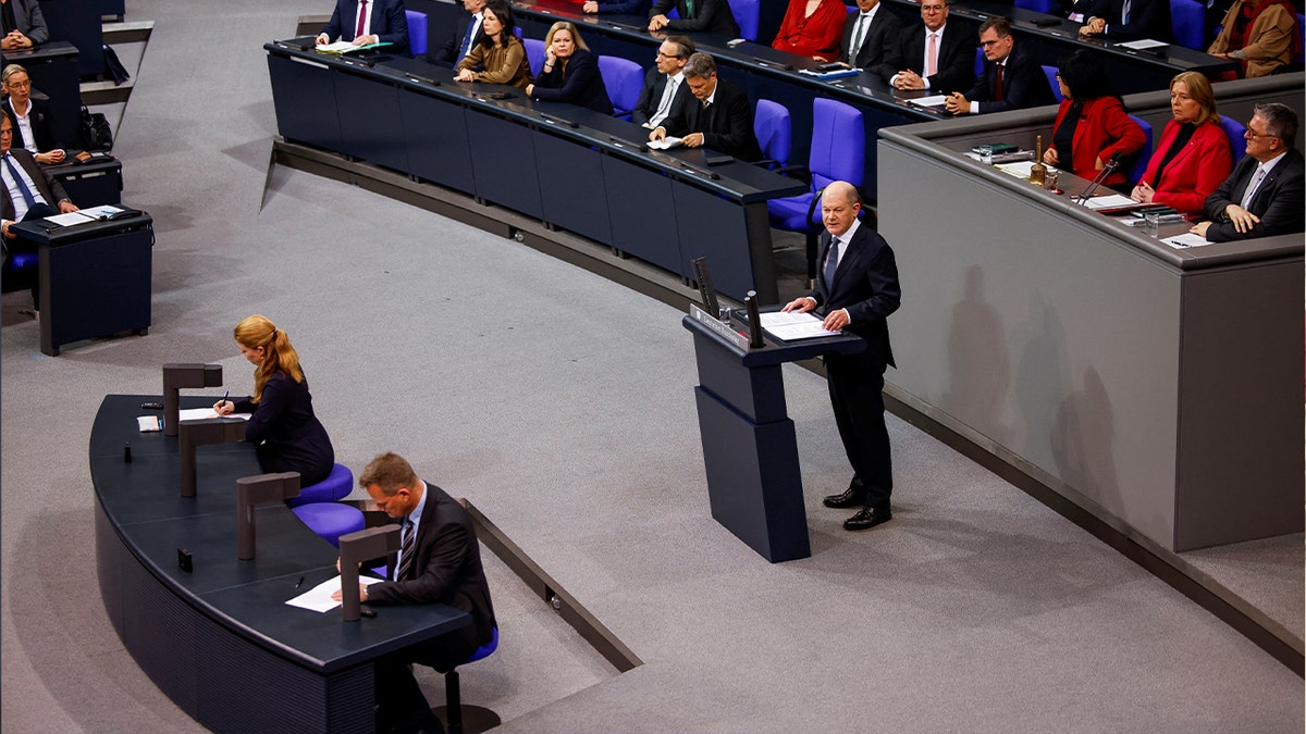 German Chancellor Olaf Scholz speaks on the podium