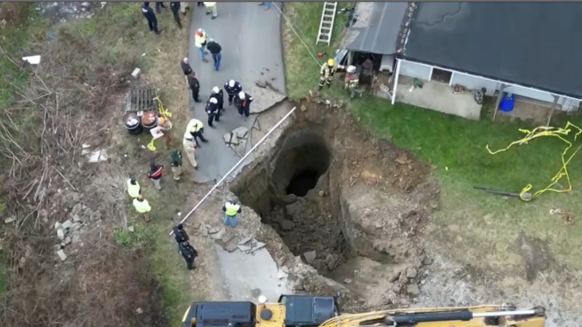 Aerials of crews working outside sinkhole