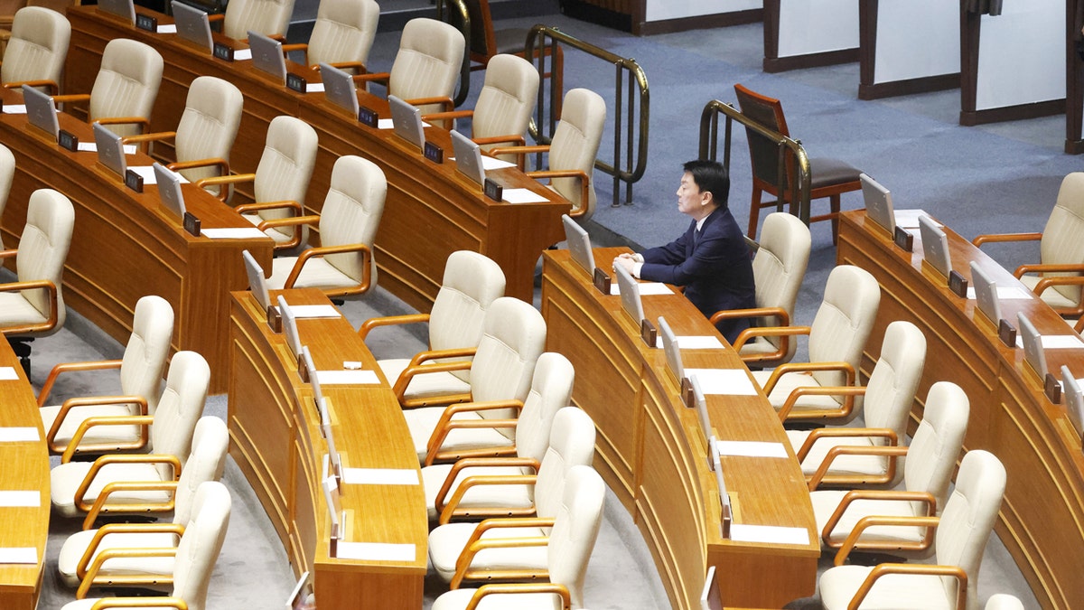 A single People Power Party lawmaker remains in the voting chamber during the impeachment vote of South Korean President Yoon Suk Yeol.