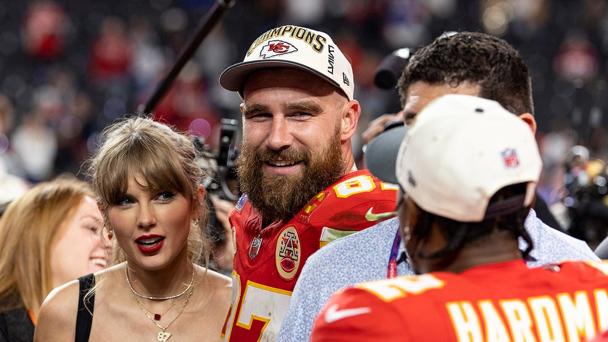 Travis Kelce and Taylor Swift react after a game