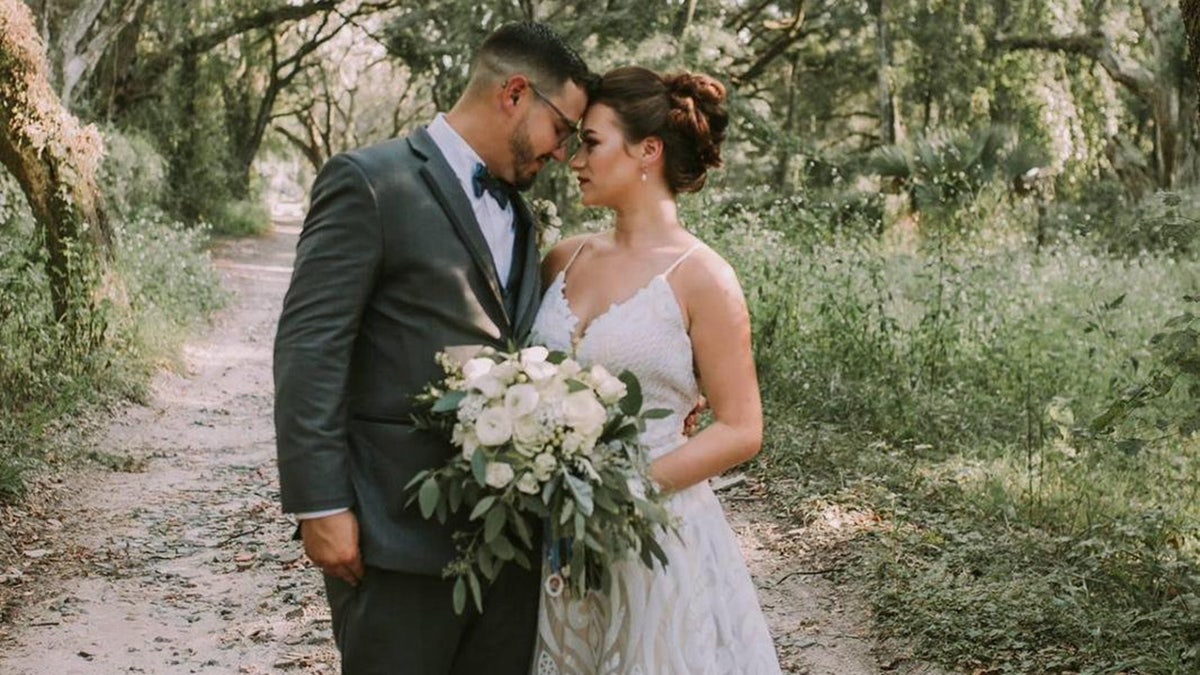 Alexandrea Acevedo and her husband, Michael, pose for photos on their wedding day