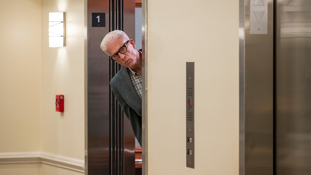 Ted Danson leaning out of an elevator