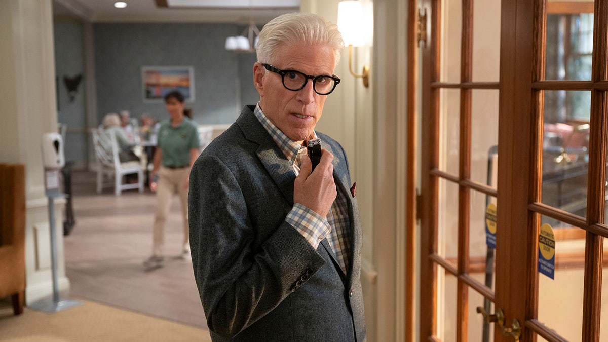 Ted Danson speaking into a spy microphone in a scene from "A Man on the Inside"