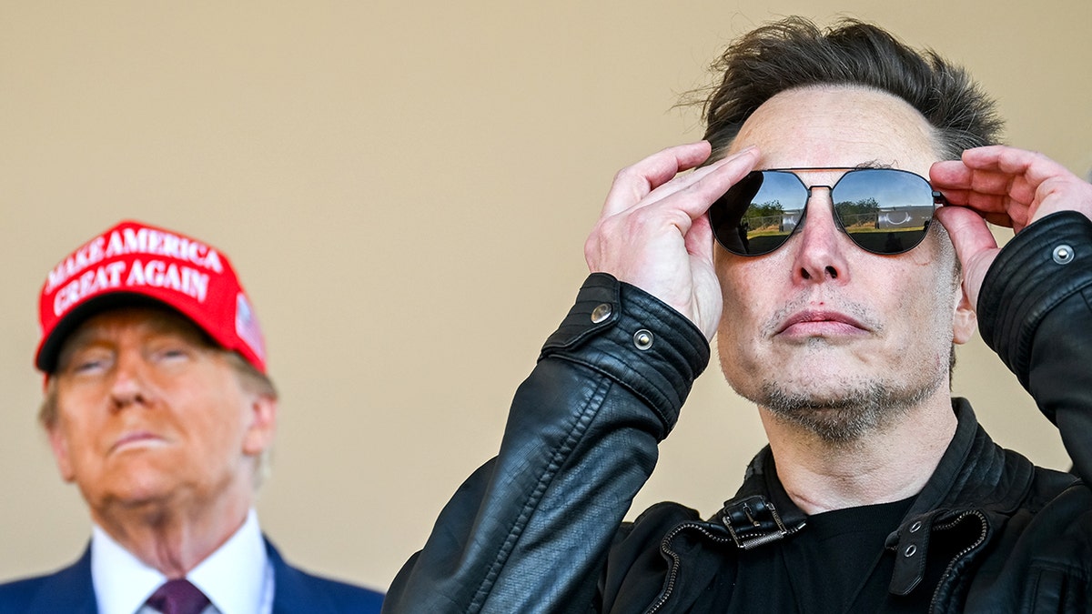 Donald Trump, wearing a red magazine hat, Elon Musk