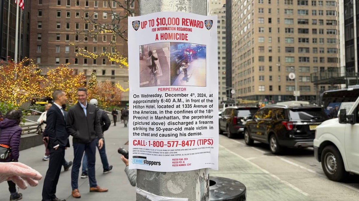 Signage posted around Midtown Manhattan asks for the public’s help in locating the suspect wanted for the shooting death of UnitedHealthcare CEO Brian Thompson