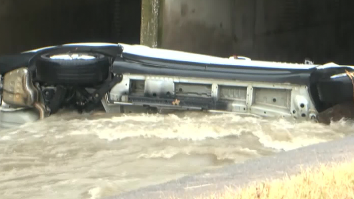 The car overturned in flood waters