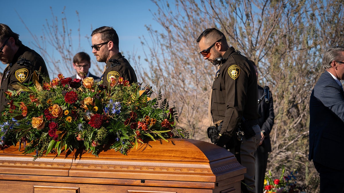 Officer Colton Pulsipher's coffin with offices paying respects