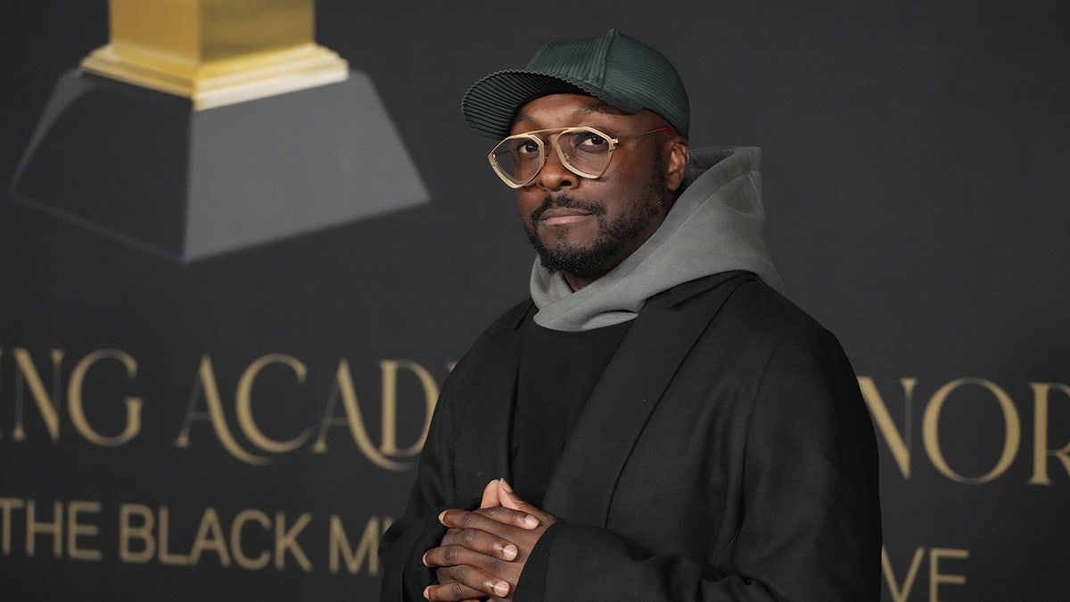 Will.i.am standing on the Grammys red carpet