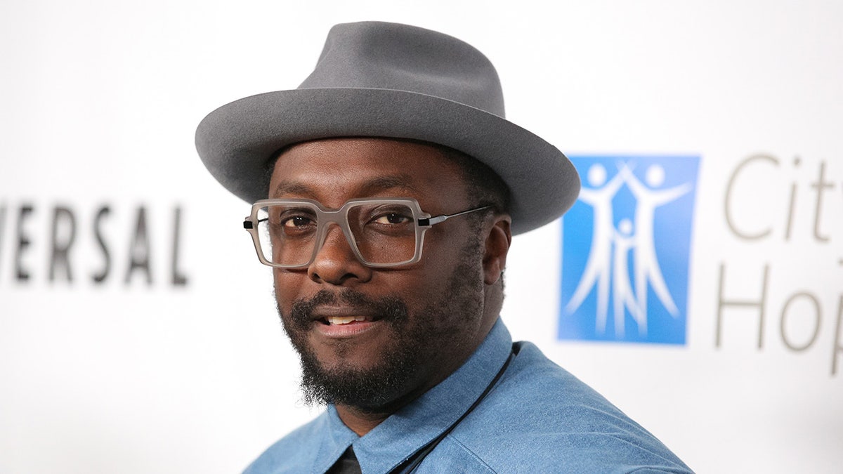 Close up of Will.i.am in glasses and a hat