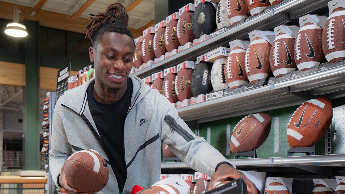 Xavier Worthy puts footballs in shopping cart