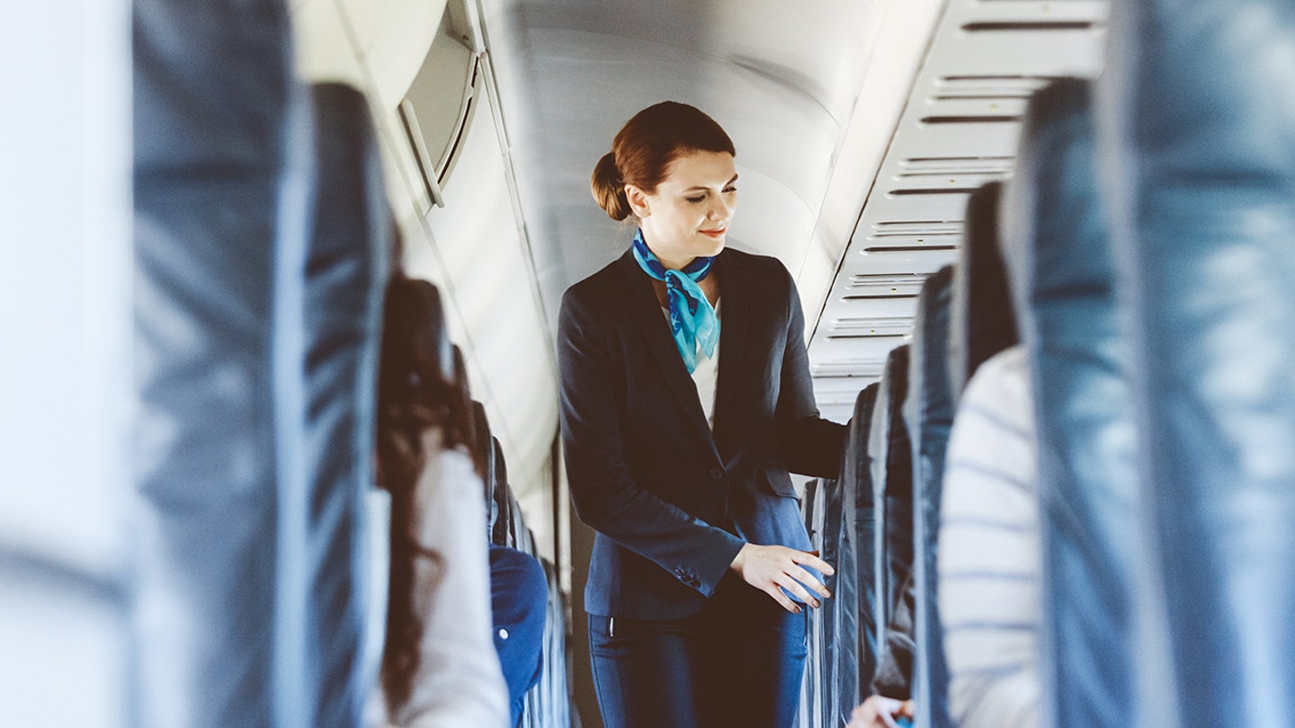 flight attendant helping passenger