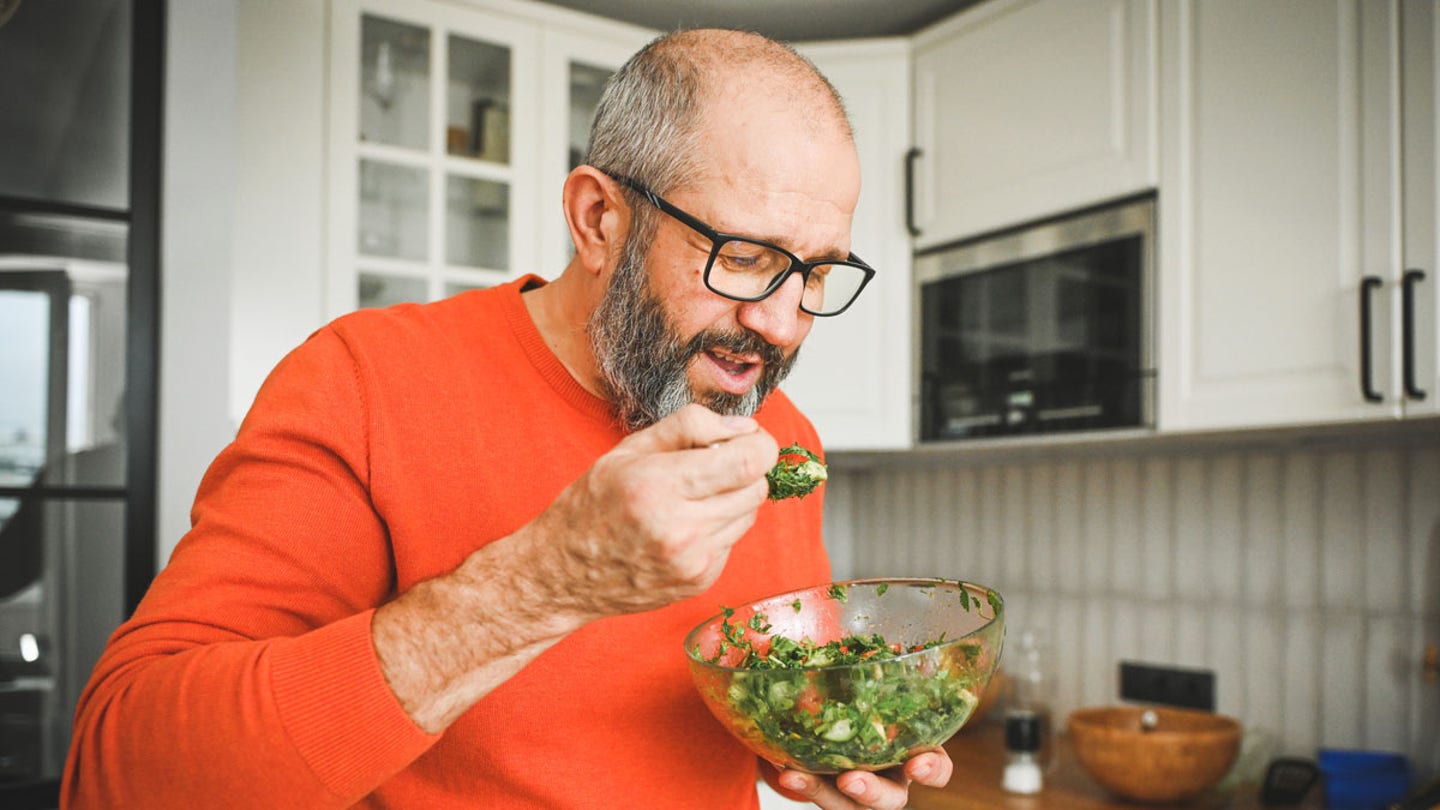 man eating salad