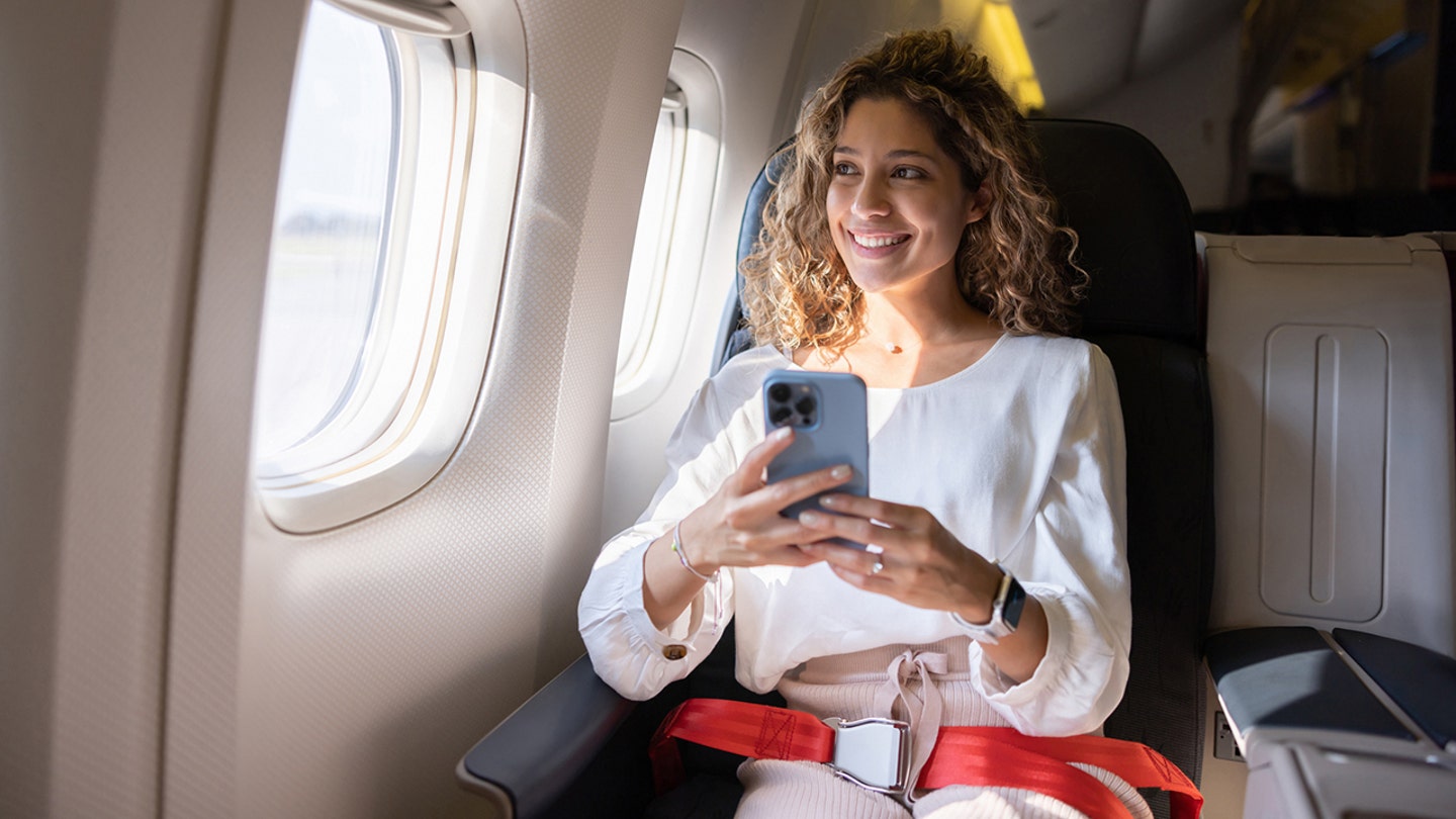 woman on phone on airplane