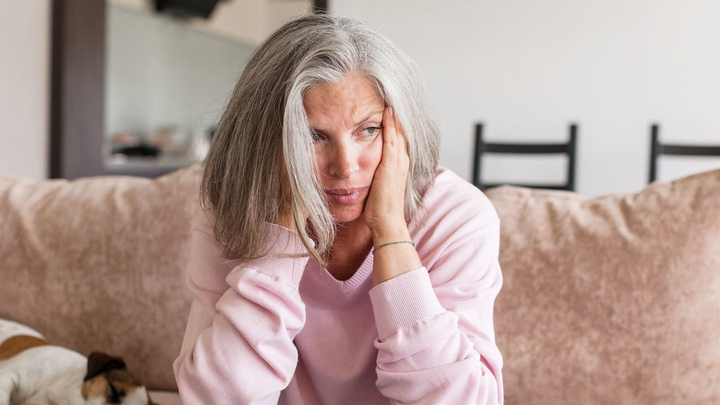 woman sad couch