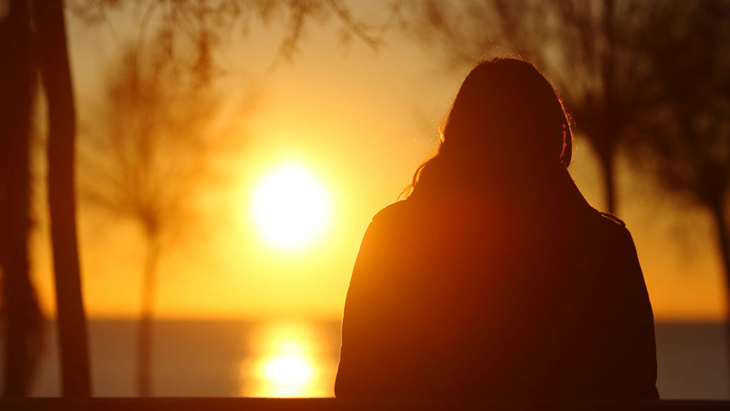 woman watching sunset