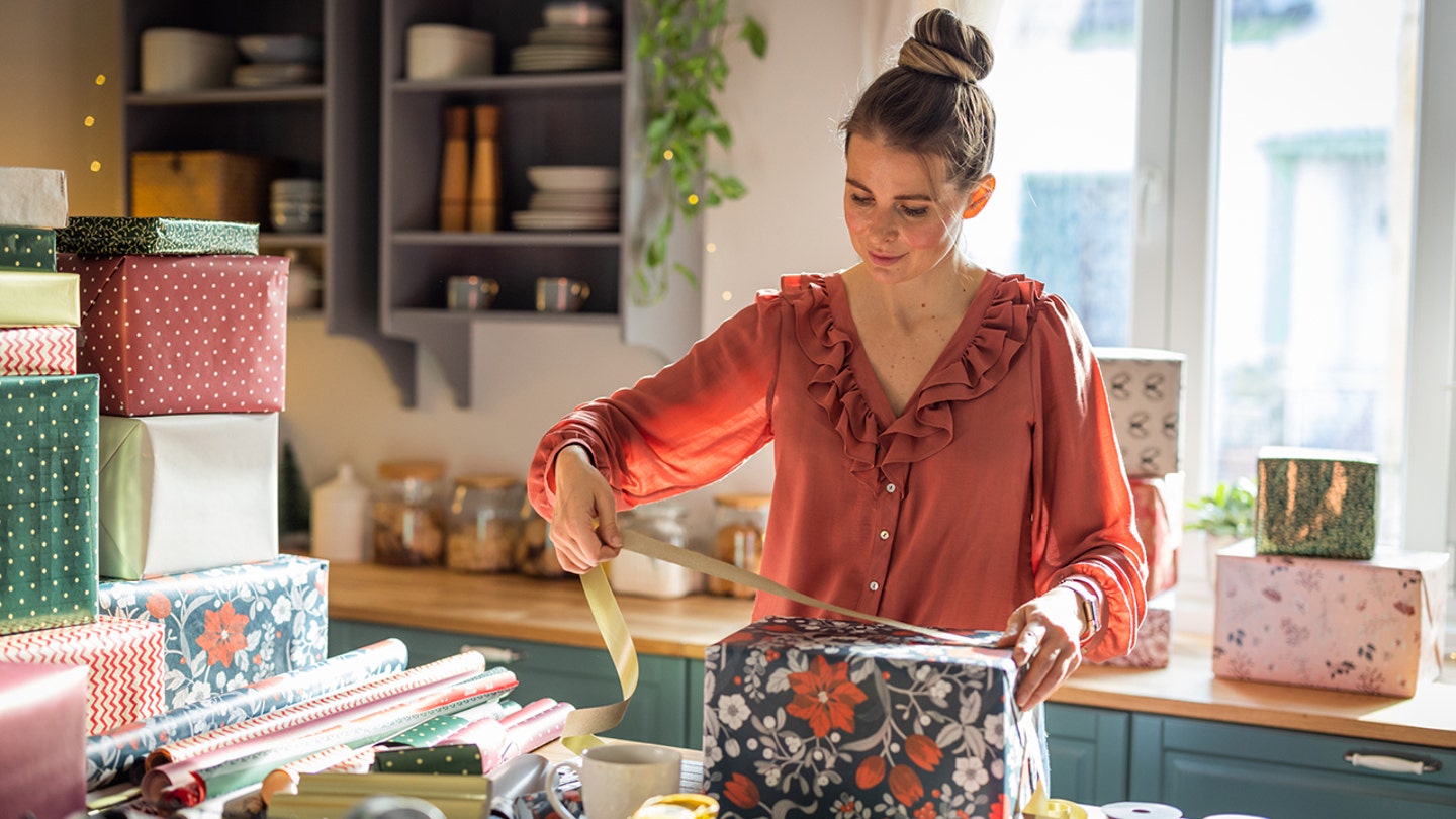 woman wrapping christmas gifts