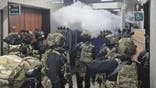 National Assembly employees spray a fire extinguisher towards soldiers at the National Assembly in Seoul, South Korea, Wednesday, Dec. 4, 2024. (Cho Da-un/Yonhap via AP)