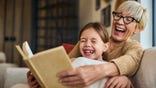 Grandma laughing with grandchild in a bright setting