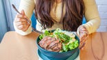 Woman eating steak