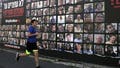 A man runs past a billboard featuring portraits of Israelis hostages held in the Gaza Strip since the Oct.7 2023 attack by Hamas militants, in Jerusalem on January 15, 2025, amid the ongoing war between Israel and Hamas. Key mediator Qatar said negotiations for a Gaza truce and hostage release deal were in their "final stages" on January 14, expressing hope an agreement could be reached "very soon". (Photo by HAZEM BADER / AFP) (Photo by HAZEM BADER/AFP via Getty Images) - Fox News