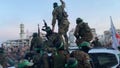 Hamas terrorists wave to Gazans during Sundays' release of three Israeli hostages. - Fox News
