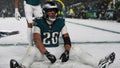 Philadelphia Eagles running back Saquon Barkley (26) sits in the snow as he celebrates his touchdown during the second half of an NFL football NFC divisional playoff game against the Los Angeles Rams on Sunday, Jan. 19, 2025, in Philadelphia. - Fox News