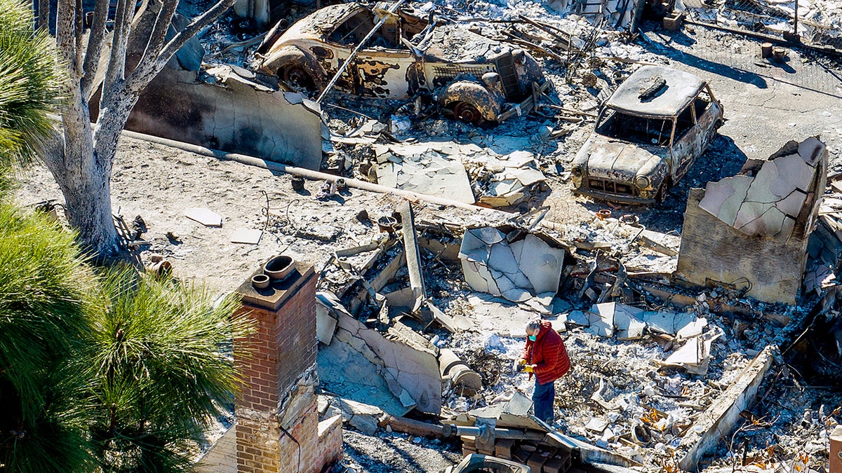 Woman searches home destroyed by Eaton Fire