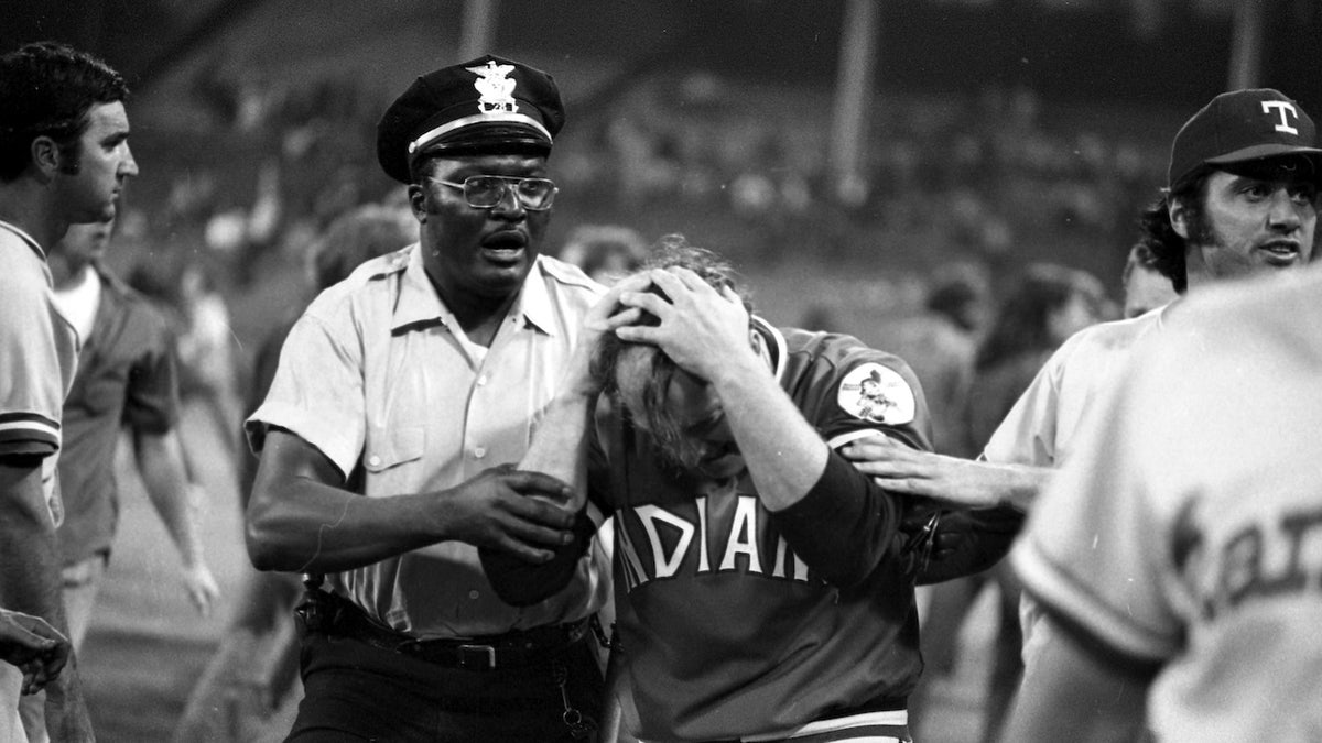 Pitcher Tom Hilgendorf of the Cleveland Indians is helped off the field after suffering a minor injury during a game against the Texas Rangers on June 4, 1974, at Cleveland Municipal Stadium.