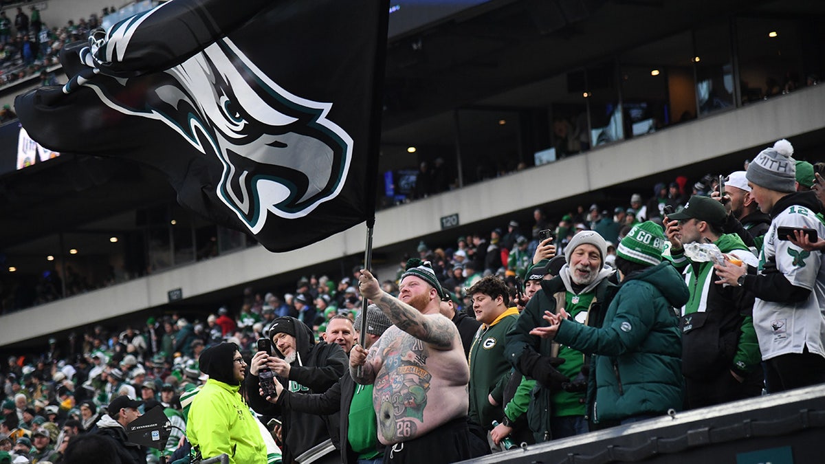 An Eagles fan raises the flag