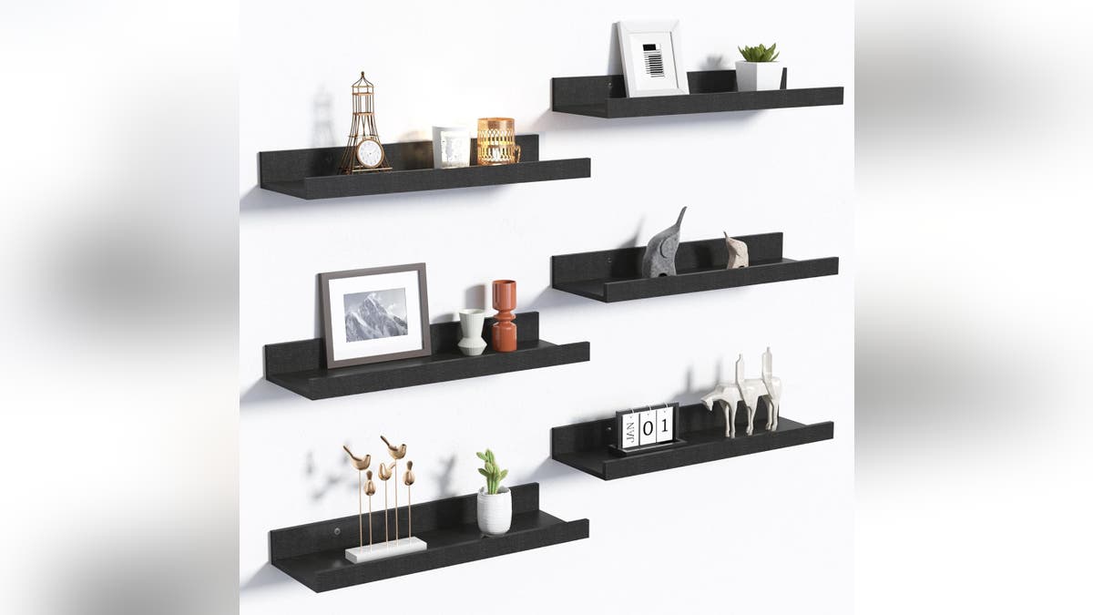 Wall-mounted floating shelves provide extra storage without taking up floor space.