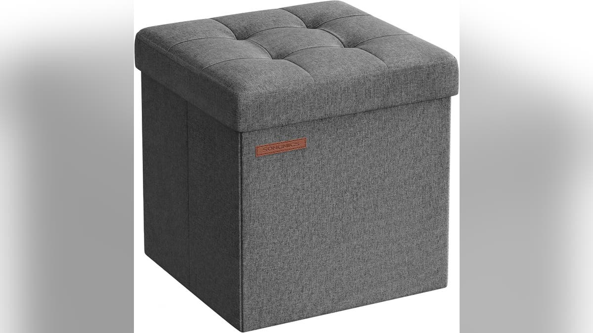 A foldaway retention  ottoman serves arsenic  seating, a footrest and hidden storage.