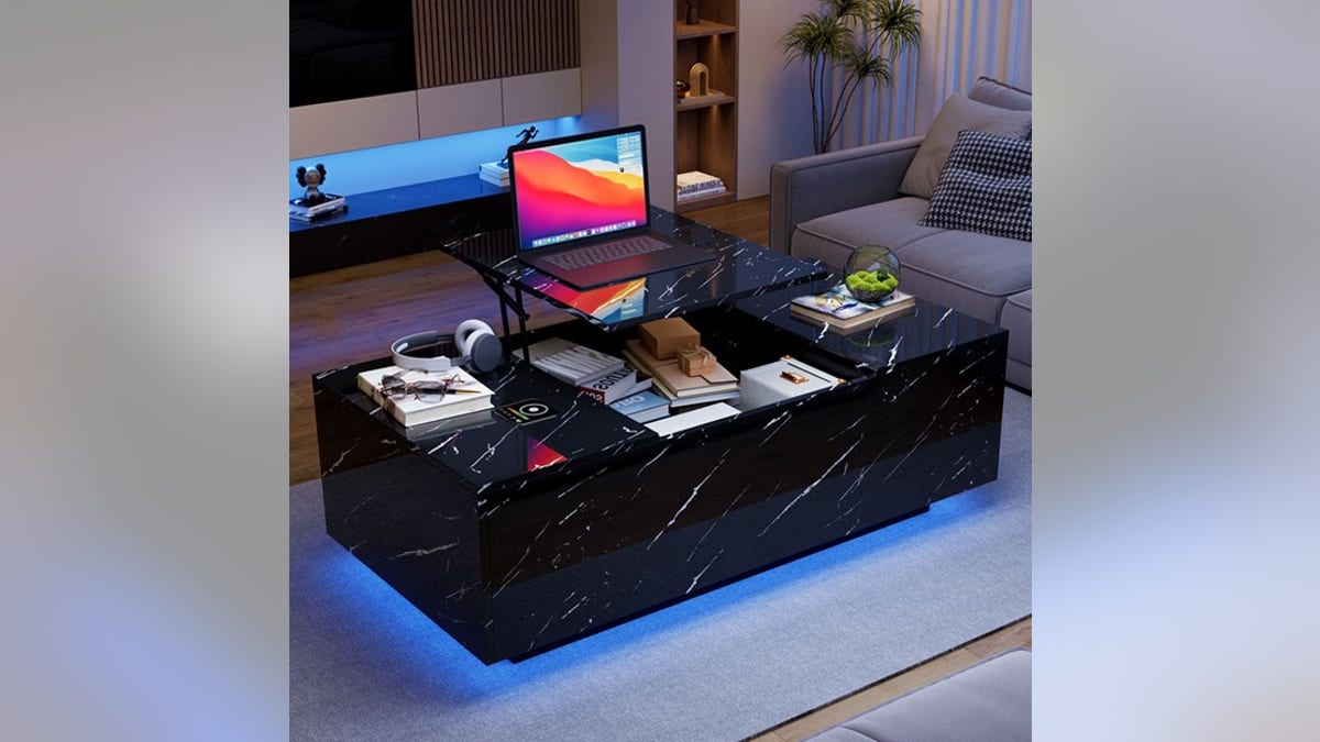 A smart coffee table has lights, speakers and even a fridge. 