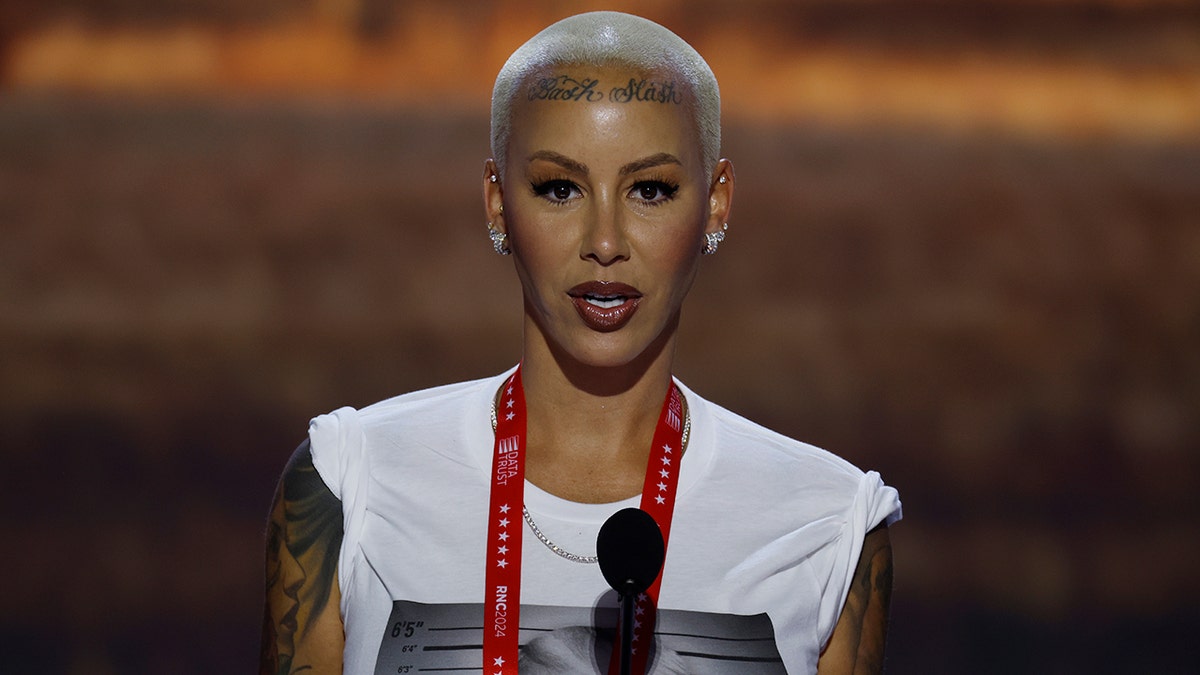 Amber Rose in a white T-shirt with Donald Trump's search for the search is behind a podium on the RNC