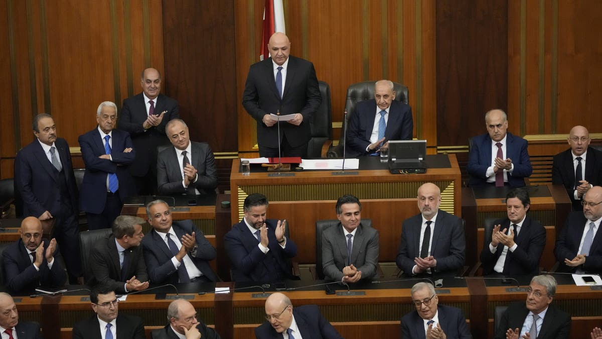 Lebanese cabinet ministers applaud the newly-elected Lebanese President Joseph Aoun, standing at the top, as he gives his first speech at Parliament after being sworn in as president in Beirut on Thursday, Jan. 9, 2025.