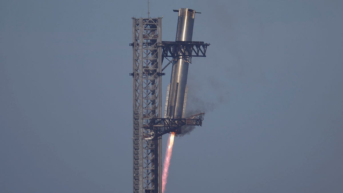 SpaceX's mega rocket Starship booster returns to the launch pad during a test flight from Starbase in Boca Chica, Texas, Thursday, Jan. 16, 2025. (AP Photo/Eric Gay)