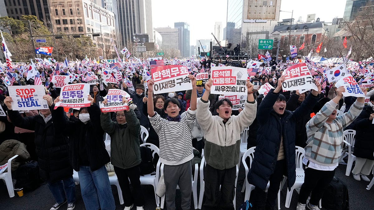 Yoon Suk Yeol supporters at a rally holding up signs