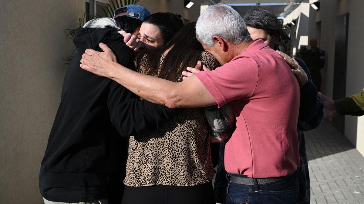 Arbel Yehoud's family hug her upon her release from Gaza on Thursday. 