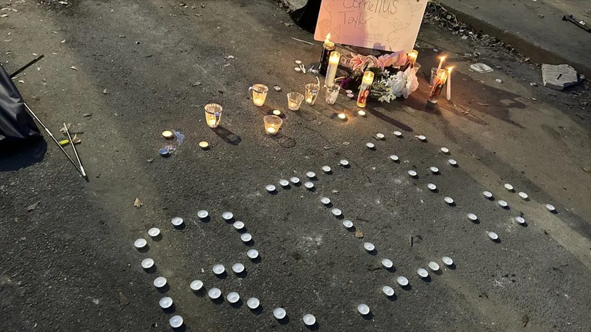 RIP sign on floor with candles