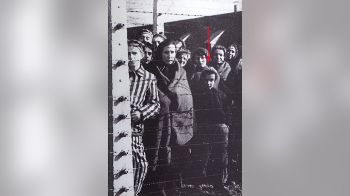 Ryszard Horowitz behind the barbed wire of Auschwitz Concentration Camp, Liberation of the camp in 1945. Photo courtesy Ryszard Horowitz.
